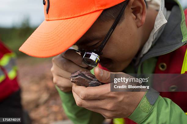 Geologist inspects a rock at a Century Iron Mines Corp. Mapping and prospecting site near Schefferville, Quebec, Canada, on Tuesday, Aug. 6, 2013....