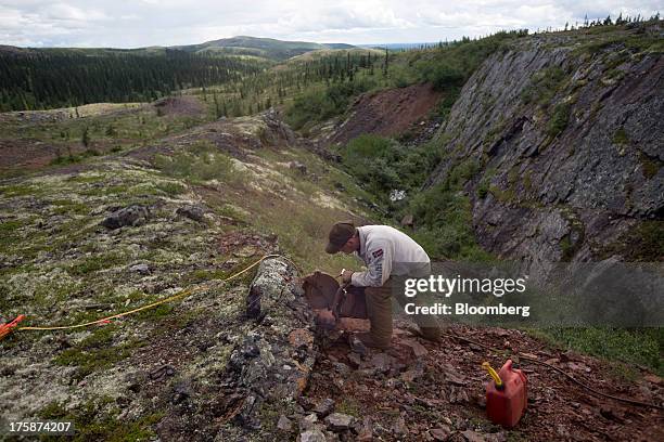 Worker prepares to extract rock samples at a Century Iron Mines Corp. Mapping and prospecting site near Schefferville, Quebec, Canada, on Tuesday,...