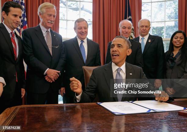 President Barack Obama makes remarks before signing the Bipartisan Student Loan Certainty Act of 2013 with Sen. Brian Schatz , Sen. Angus King , Sen....