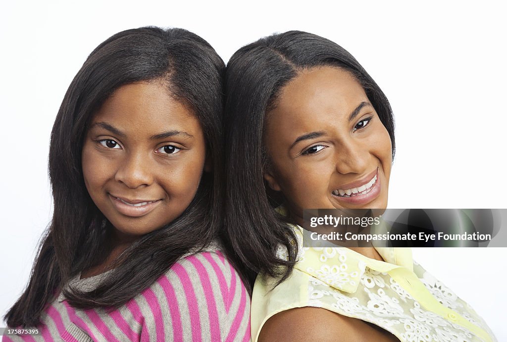 Close up portrait of smiling sisters