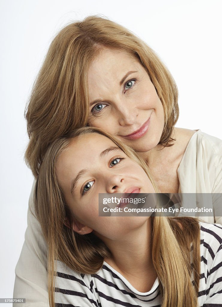 Close up portrait of smiling mother and daughter