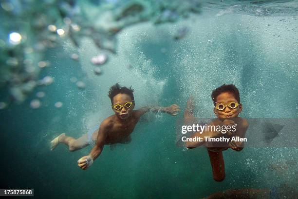 bajau sea gypsy children playing underwater - free diving stock pictures, royalty-free photos & images