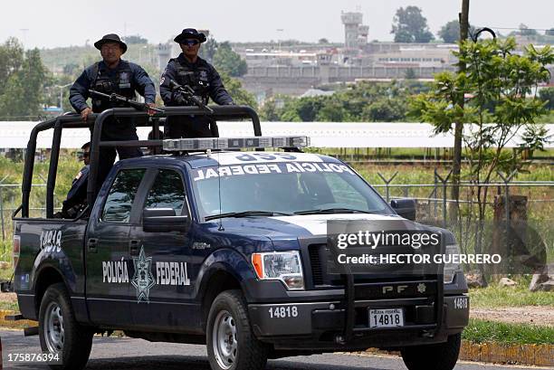 Unit of the Mexican Federal Police patrols the surroundings of the Puente Grande State prison in Zapotlanejo, Jalisco State, Mexico, on 9 August,...