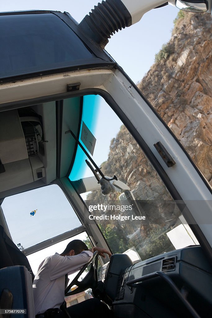 Sleeping tour bus driver outside Jeita Grotto