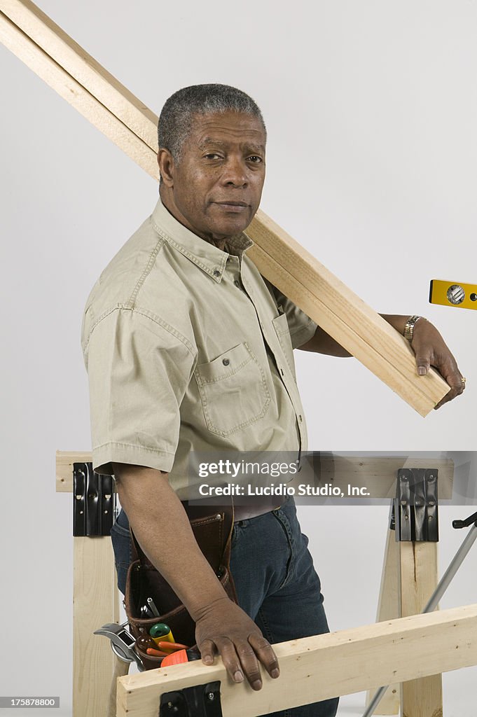 Man Doing Home Improvement, Carrying 2x4 Lumber