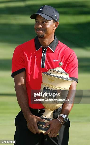 Tiger Woods holds the Gary Player Cup trophy after the Final Round of the World Golf Championships-Bridgestone Invitational at Firestone Country Club...