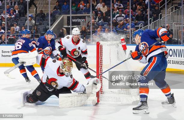Joonas Korpisalo of the Ottawa Senators makes the glove save on Bo Horvat of the New York Islanders during the second period at UBS Arena on October...