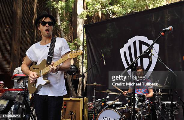 Singer/guitarist Keith Jeffery and drummer Michael Jeffery of Atlas Genius perform live at Warner Bros. Records Boutique Store on August 9, 2013 in...