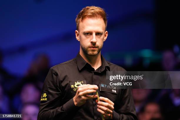 Judd Trump of England chalks the cue in the fourth round match against Noppon Saengkham of Thailand on day five of 2023 Northern Ireland Open at...