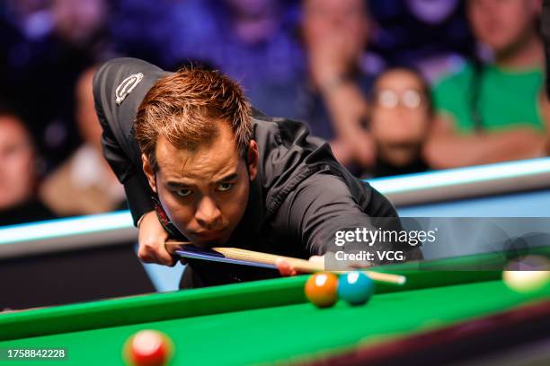 Noppon Saengkham of Thailand plays a shot in the fourth round match against Judd Trump of England on day five of 2023 Northern Ireland Open at...