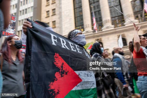 Supporters of Palestine hold a rally in New York's financial district as the fighting continues in Gaza on October 26, 2023 in New York City....