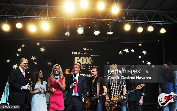 Fox and Freinds hosts interview Eli Young Band during "FOX & Friends" All American Concert Series outside of FOX Studios on August 9, 2013 in New...