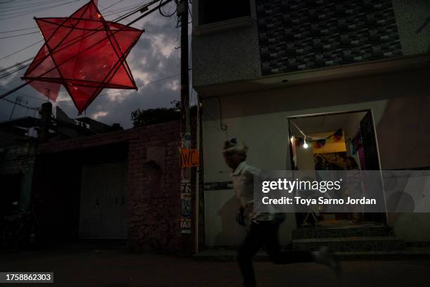 Boy runs in the Mixquic neighborhood during 'Day of the Dead' celebrations on November 1, 2023 in Mexico City, Mexico. The Day of the Dead takes...