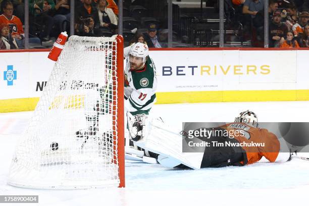 Marcus Foligno of the Minnesota Wild scores past Carter Hart of the Philadelphia Flyers during the third period at Wells Fargo Center on October 26,...