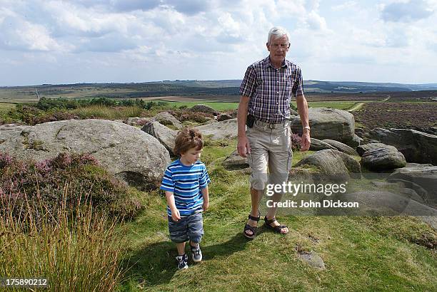 grandfather and grandson walking together - striped tshirt stock pictures, royalty-free photos & images