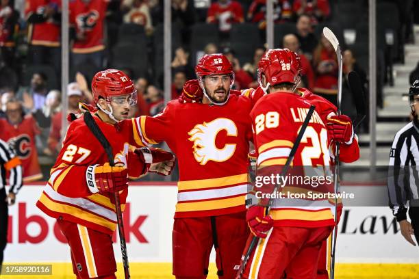 Calgary Flames Defenceman MacKenzie Weegar celebrates a goal with Calgary Flames Right Wing Matthew Coronato , Calgary Flames Left Wing Jonathan...