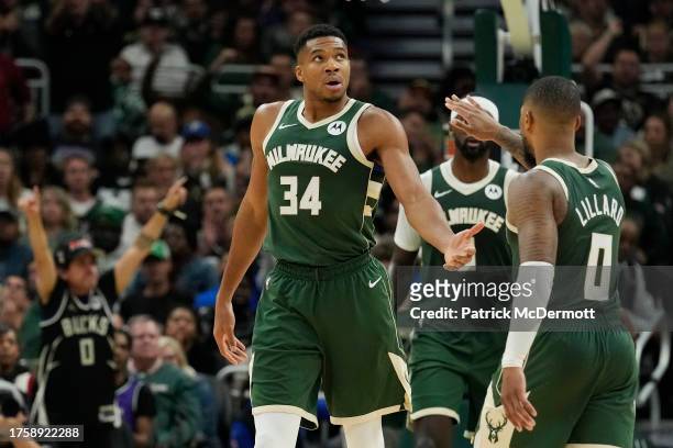 Giannis Antetokounmpo and Damian Lillard of the Milwaukee Bucks celebrate against the Philadelphia 76ers in the second half at Fiserv Forum on...