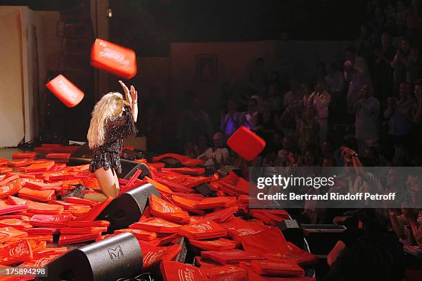 Christelle Chollet performs after the traditional throw of cushions at the final of her one woman show "The New Show", written and set stage by Remy...