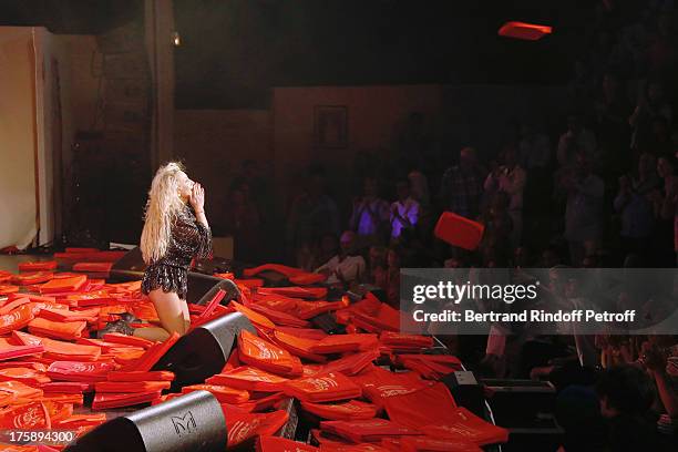 Christelle Chollet performs after the traditional throw of cushions at the final of her one woman show "The New Show", written and set stage by Remy...