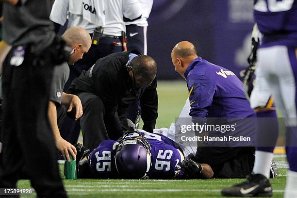 Trainers check on Sharrif Floyd of the Minnesota Vikings after being injured on a play during the second quarter of the game against the Houston...