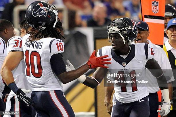 Cierre Wood of the Houston Texans congratulates teammate DeAndre Hopkins on scoring a touchdown during the second quarter of the game against the...