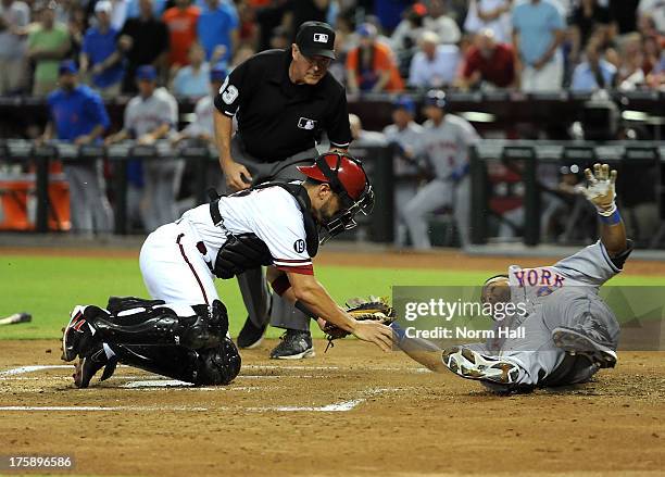 Wil Nieves of the Arizona Diamondbacks tags out Marlon Byrd of the New York Mets at home plate at Chase Field on August 9, 2013 in Phoenix, Arizona.