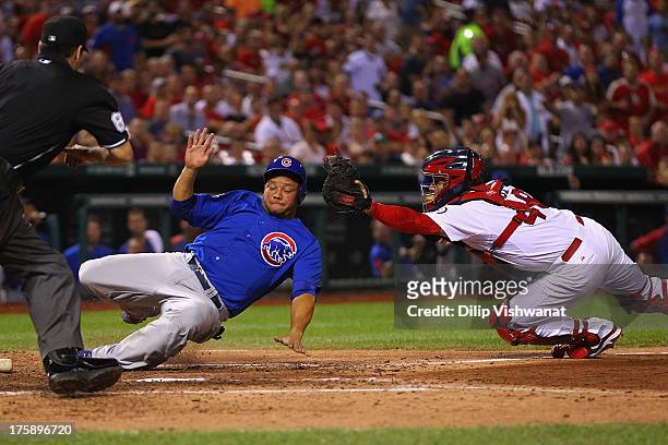 Welington Castillo of the Chicago Cubs scores a run against Tony Cruz of the St. Louis Cardinals in the seventh inning at Busch Stadium on August 9,...