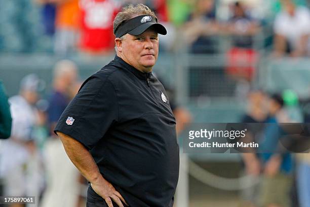 Head coach Chip Kelly of the Philadelphia Eagles stands on the field during warm-ups before a preseason game against the New England Patriots on...