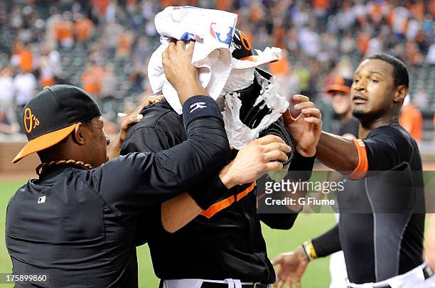 Ryan Flaherty of the Baltimore Orioles gets shaving creamed by Alexi Casilla and Adam Jones after an 11-8 victory against the Seattle Mariners at...