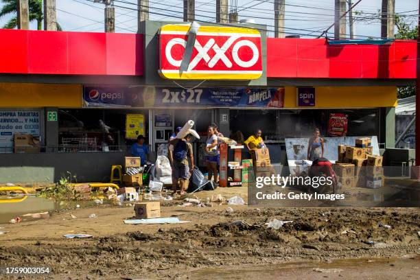 People carry products from a looted store after hurricane Otis hit Acapulco on October 26, 2023 in Acapulco, Mexico. Otis made landfall through the...