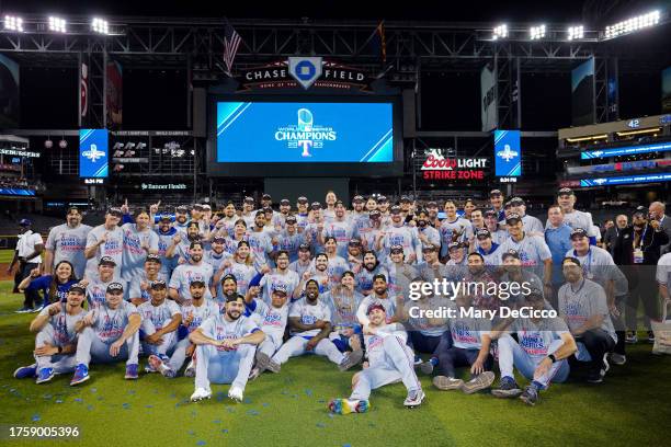Members of the Texas Rangers pose for a photo on the field after the Rangers defeated the Arizona Diamondbacks in Game 5 of the 2023 World Series at...