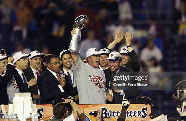 Head coach Jon Gruden of the Tampa Bay Buccaneers holds aloft the Lombardi Trophy as he celebrates after the victory over the Oakland Raiders in...