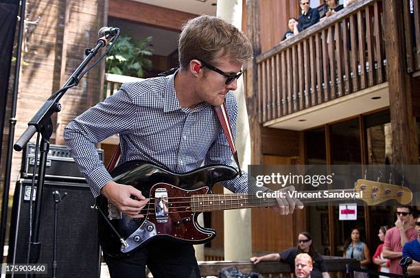 Bassist Steven Jeffery of Atlas Genius performs at the WBR Summer Sessions at Warner Bros. Records boutique store on August 9, 2013 in Burbank,...