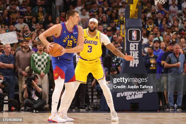 Anthony Davis of the Los Angeles Lakers defends Nikola Jokic of the Denver Nuggets during the first half at Ball Arena on October 24, 2023 in Denver,...