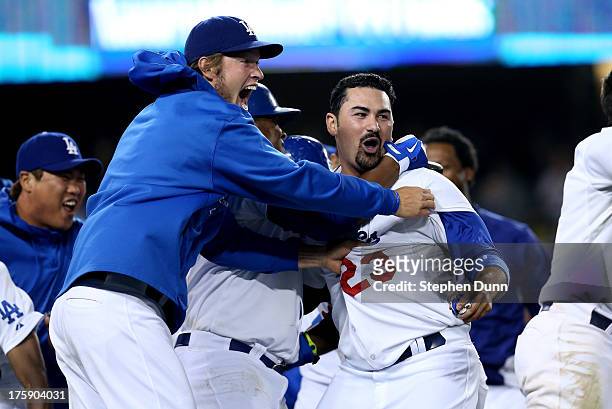 Adrian Gonzalez and Clayton Kershaw of the Los Angeles Dodgers celebrates after Gonzalez scored the winning run in the ninth inning against the Tampa...