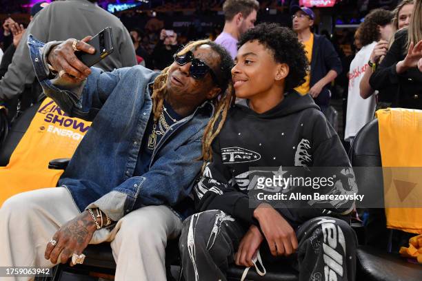 Lil Wayne and his son Kameron Carter attend a basketball game between the Los Angeles Lakers and the Phoenix Suns at Crypto.com Arena on October 26,...