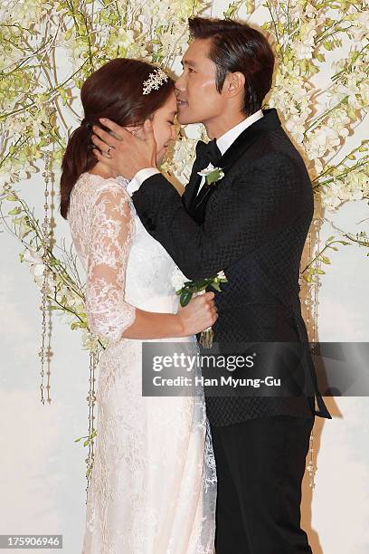 South Korean actors Lee Byung-Hun and Rhee Min-Jung pose for photographs before their wedding at the Hyatt Hotel on August 10, 2013 in Seoul, South...