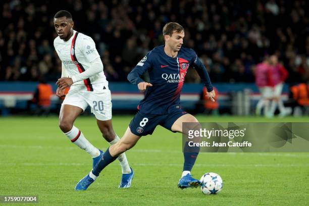Lee Kang-in of PSG, left Pierre Kalulu of AC Milan in action during the UEFA Champions League match between Paris Saint-Germain and AC Milan at Parc...