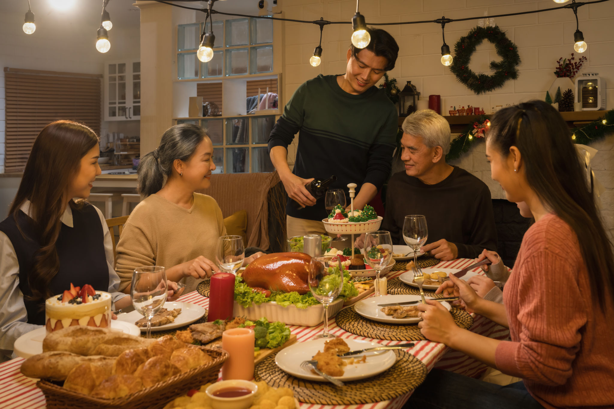 happiness Asian family with multi generation together on thanksgiving and Christmas celebration traditional dinner at home happiness Asian family with multi generation together on thanksgiving and Christmas celebration traditional dinner at home