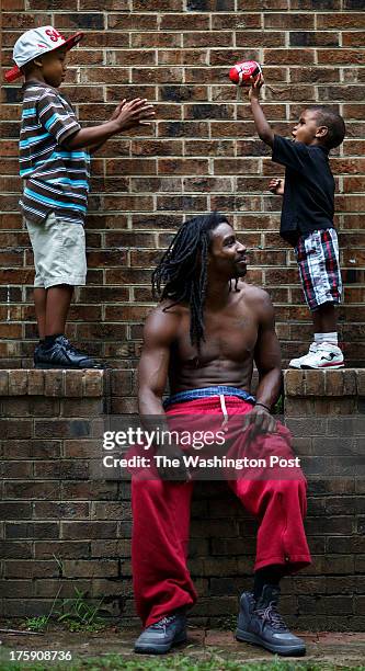 Greensboro, NC - August 7 - Noah Amerson, center, plays football in his back yard with his sons Malikah Pon and Micah Amerson at his home in...