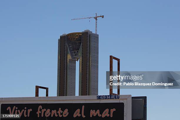 Billboard reading 'To live in front of the sea' stands in front of the unfinished InTempo building on August 9, 2013 in Benidorm, Spain. The...