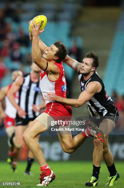Kurt Tippett of the Swans marks in front of Nathan Brown of the Magpies during the round 20 AFL match between the Sydney Swans and the Collingwood...