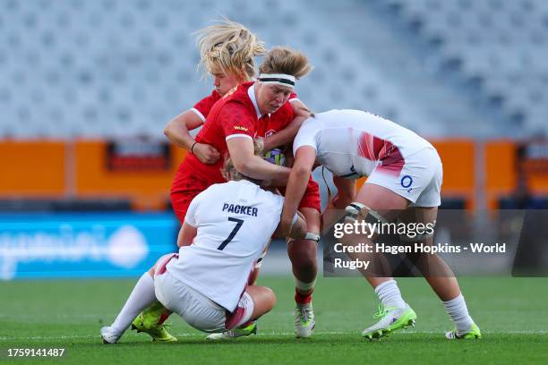 Tyson Beukeboom of Canada is tackled by Marlie Packer and Morwenna Talling of England during the WXV1 match between England and Canada at Forsyth...