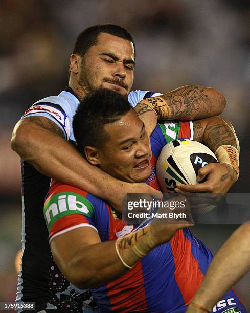 Joey Leilua of the Knights is tackled during the round 22 NRL match between the Cronulla Sharks and the Newcastle Knights at Remondis Stadium on...