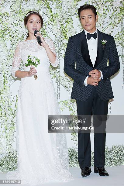 South Korean actors Lee Byung-Hun and Rhee Min-Jung pose for photographs before their wedding at the Hyatt Hotel on August 10, 2013 in Seoul, South...