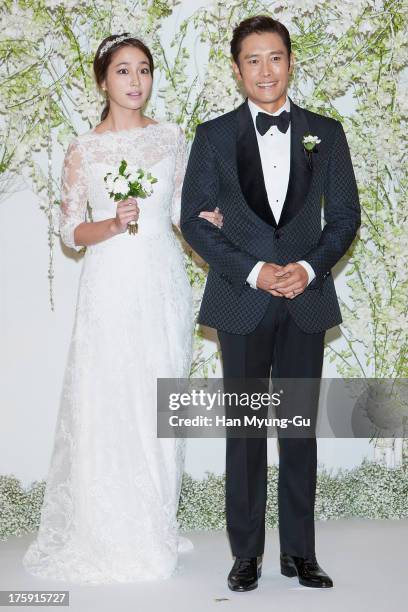 South Korean actors Lee Byung-Hun and Rhee Min-Jung pose for photographs before their wedding at the Hyatt Hotel on August 10, 2013 in Seoul, South...