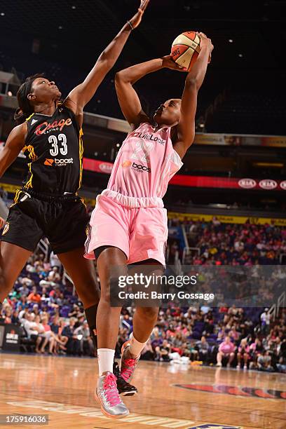 Charde Houston of the Phoenix Mercury shoots against Tiffany Jackson-Jones of the Tulsa Shock on August 9, 2013 at U.S. Airways Center in Phoenix,...