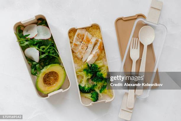 healthy food concept. lunch box filled with avocado, arugula, couscous, broccoli and chicken. flat lay - bento box stock pictures, royalty-free photos & images