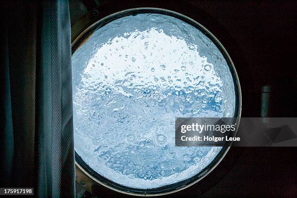 view through porthole window of sailing ship - porthole stock pictures, royalty-free photos & images