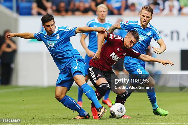 Robert Mak of Nuernberg is challenged by Kevin Volland and Eugen Polanski of Hoffenheim during the Bundesliga match between 1899 Hoffenheim and 1. FC...